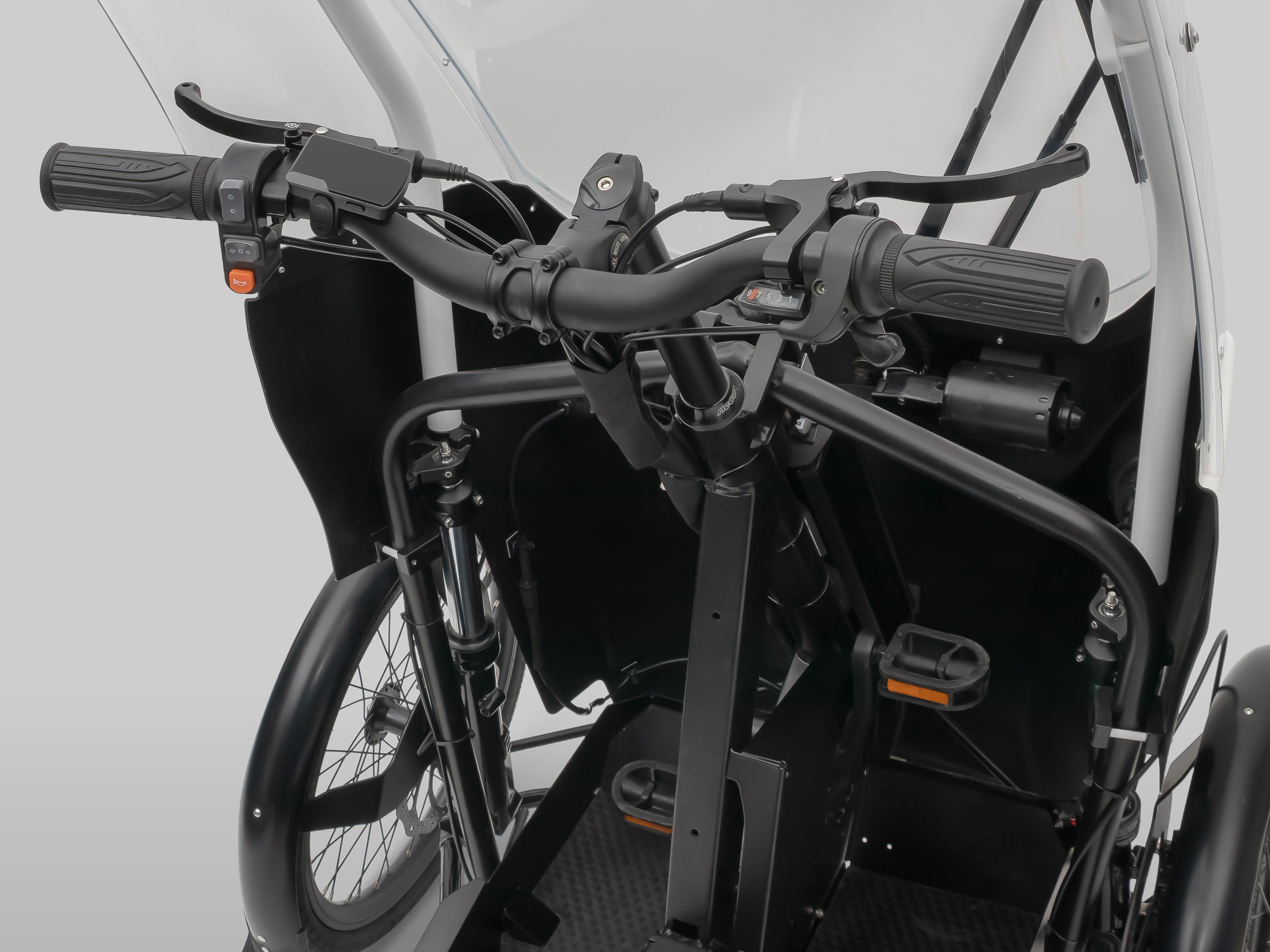 Interior view of Veemo enclosed electric velomobile showing steering and cockpit